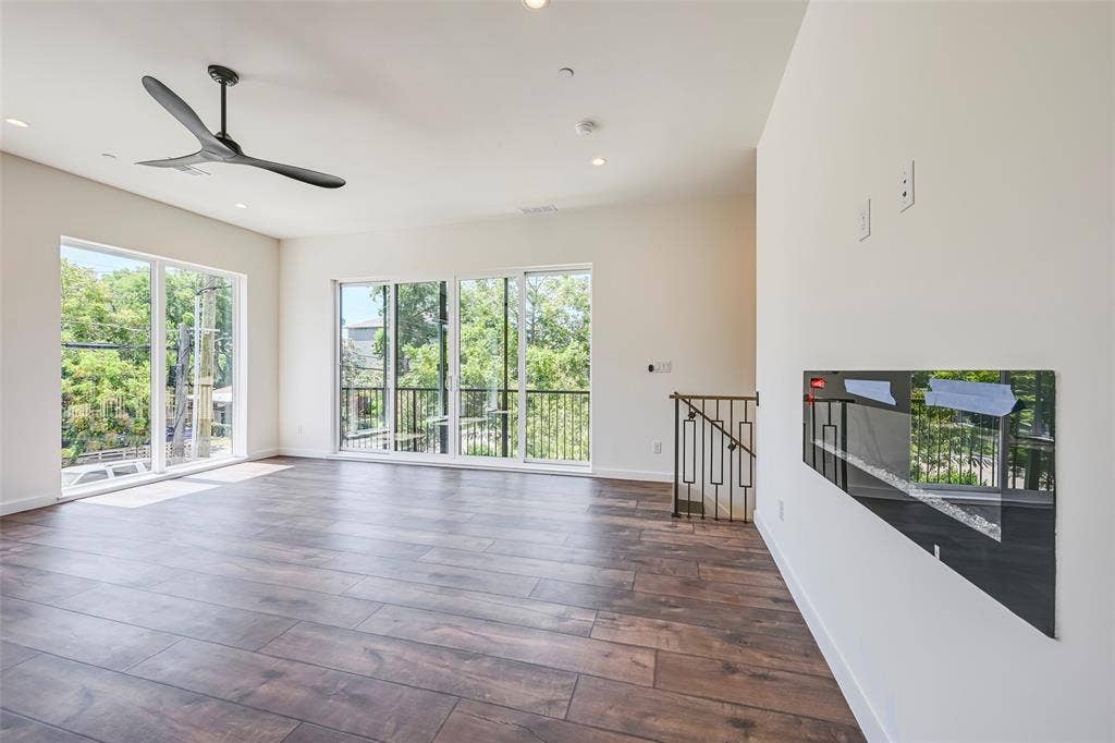 2247 Mail Avenue, #103, Dallas, TX 75235 Wood-finish flooring, recessed lighting, ceiling fan, multiple glass doors, and a decorative railing