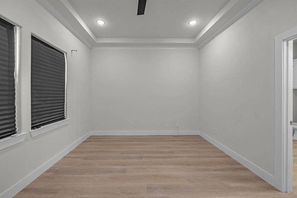 5511 Black Pine Circle, Granbury, TX 76048 Tray ceiling with recessed lighting, wood-finish flooring, and white trim