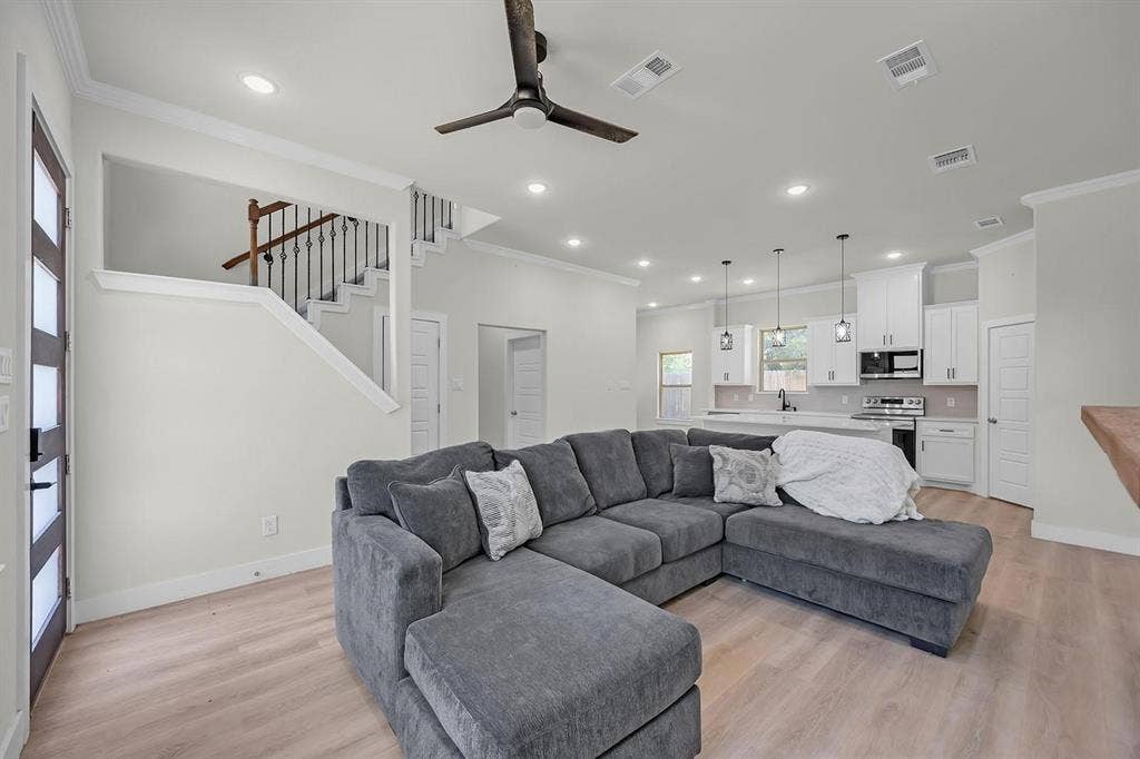 5511 Black Pine Circle, Granbury, TX 76048 Open-concept living area featuring wood-finish flooring, recessed lighting, and a contemporary ceiling fan