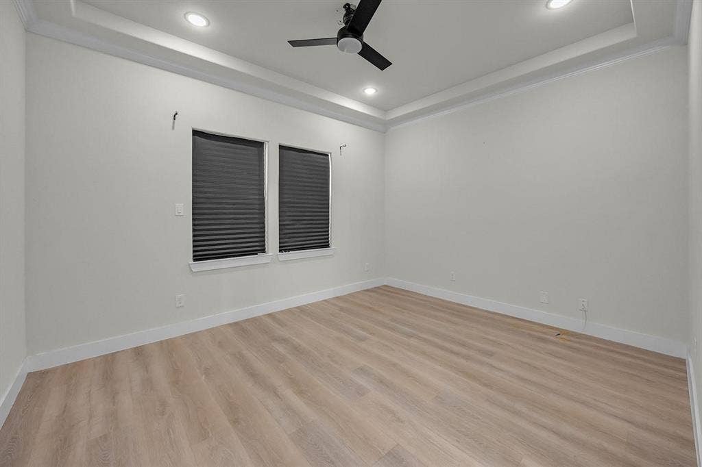 5511 Black Pine Circle, Granbury, TX 76048 Recessed lighting, crown molding, wood-finish flooring, two windows with blinds, and a ceiling fan