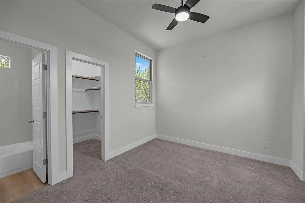 5511 Black Pine Circle, Granbury, TX 76048 Recessed lighting, ceiling fan, plush carpeting, built-in closet shelving, and a window for natural light