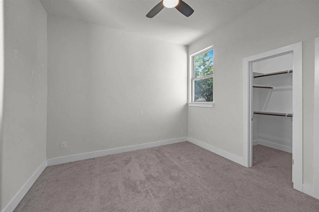 5511 Black Pine Circle, Granbury, TX 76048 Neutral gray carpeting, white walls, and a window with white trim