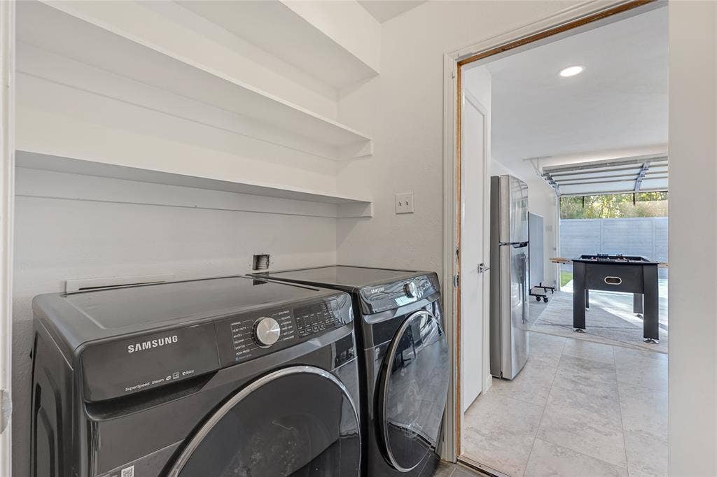 6802 Duffield Drive, Dallas, TX 75248 Utility area with built-in shelving, tile flooring, and a flush-mount overhead light fixture