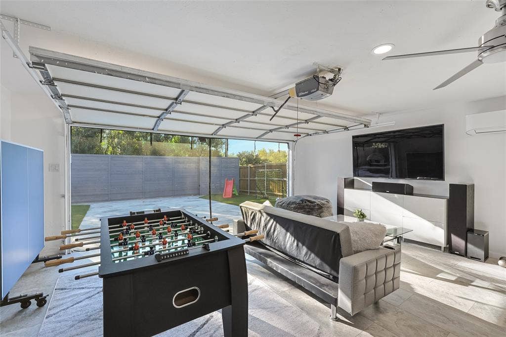 6802 Duffield Drive, Dallas, TX 75248 Spacious interior with an overhead garage door, recessed ceiling lighting, a ceiling fan, and light-toned flooring