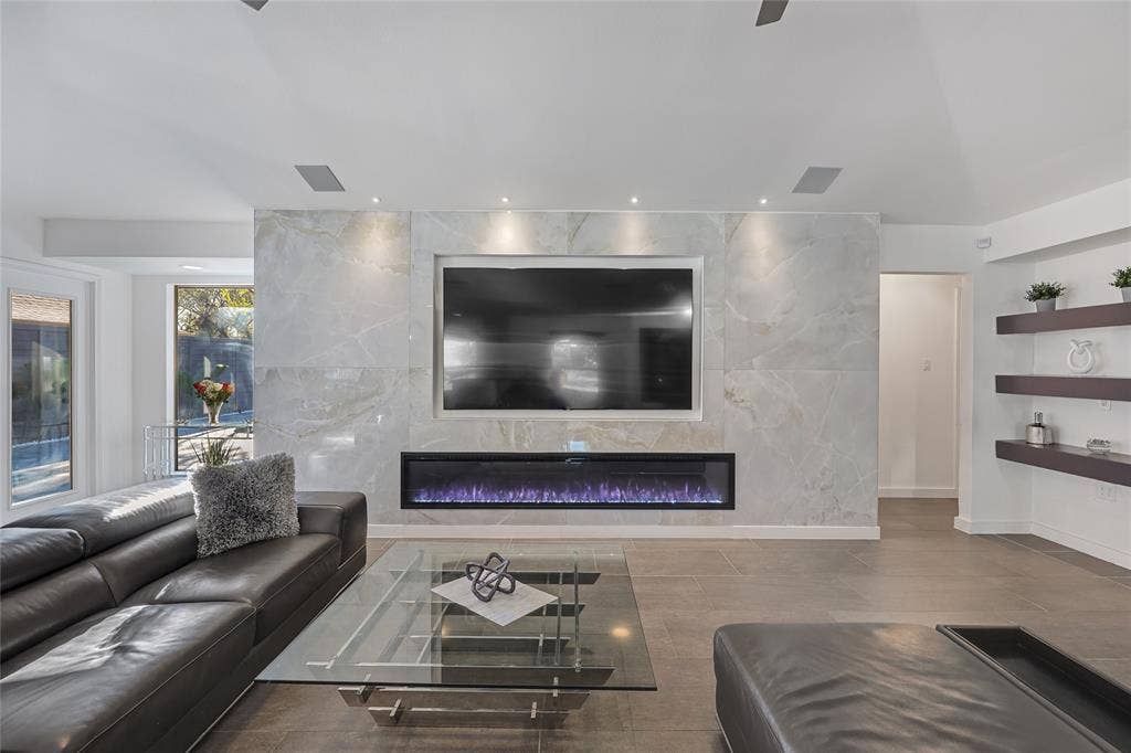 6802 Duffield Drive, Dallas, TX 75248 Marble-look accent wall with an integrated linear electric fireplace