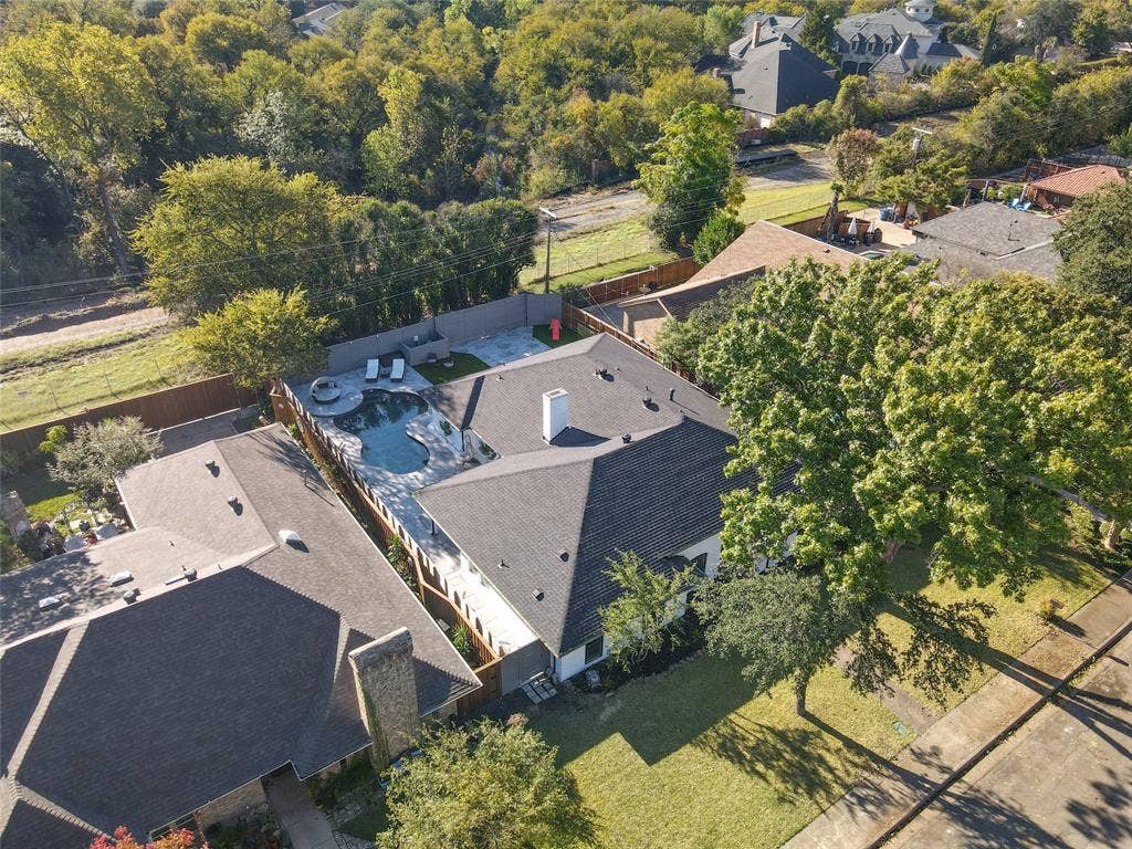 6802 Duffield Drive, Dallas, TX 75248 Property featuring an irregularly shaped pool, stone coping, and a surrounding patio