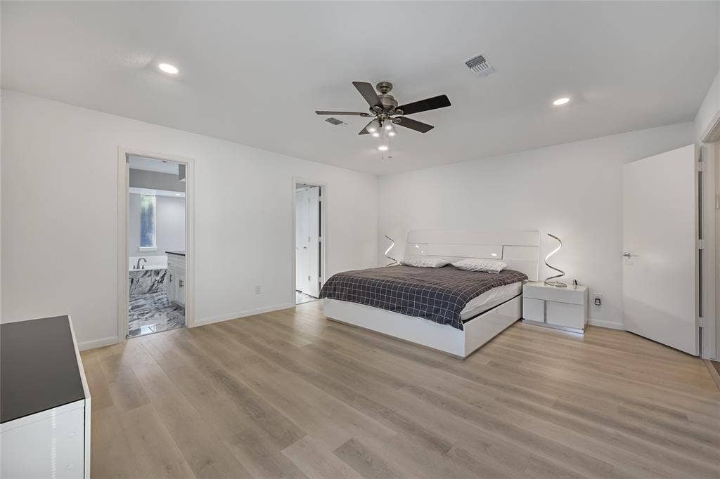 6802 Duffield Drive, Dallas, TX 75248 Spacious room with wood-finish flooring, recessed ceiling lighting, and a ceiling fan with integrated lighting