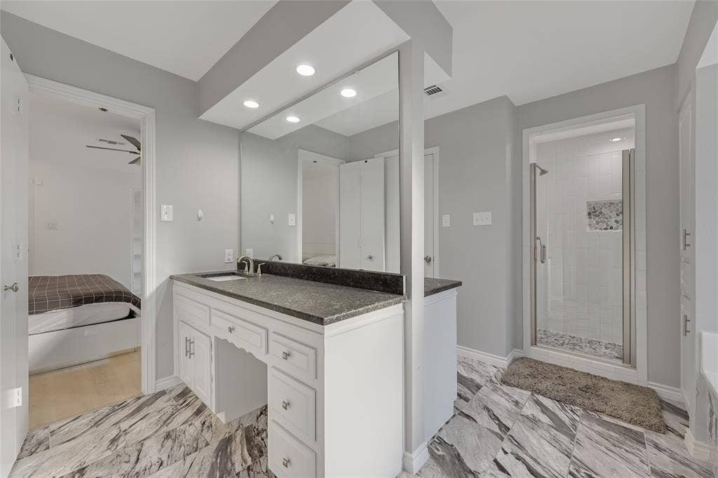 6802 Duffield Drive, Dallas, TX 75248 White vanity with a dark countertop and undermount sink
