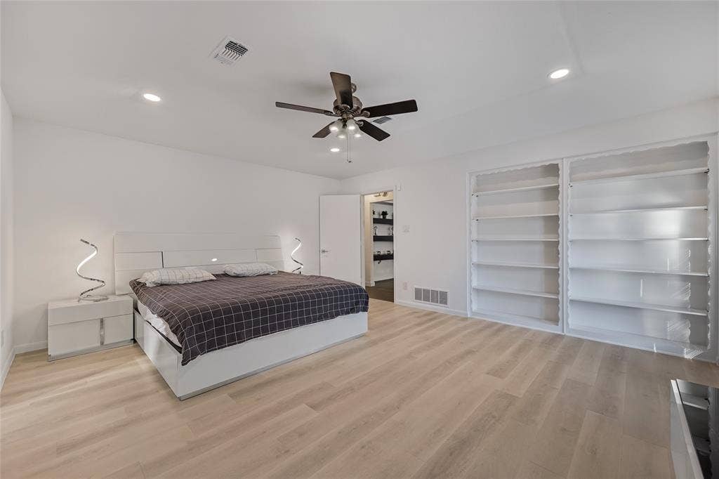 6802 Duffield Drive, Dallas, TX 75248 Recessed lighting, wood-finish flooring, ceiling fan with light fixture, built-in shelving, and white walls