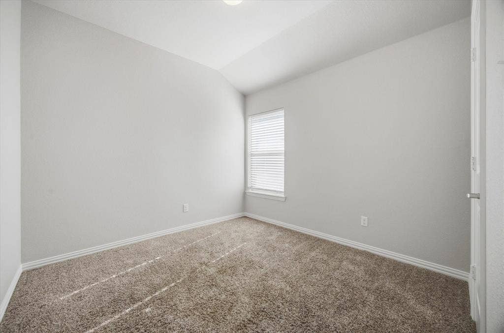 408 Northgate Drive, Terrell, TX 75160 Neutral-toned carpeting, white window blinds, and light gray wall paint