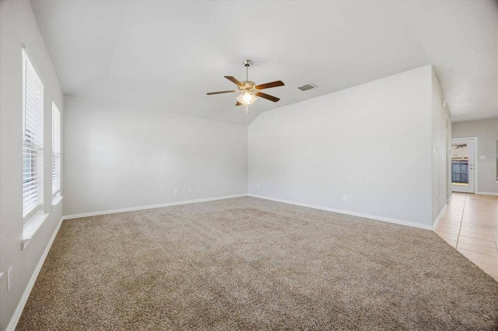 408 Northgate Drive, Terrell, TX 75160 Spacious room with plush carpeting, neutral wall finishes, and multiple windows for natural light