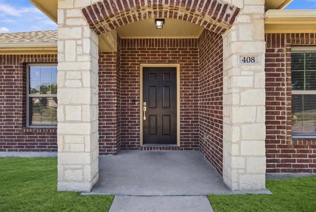 408 Northgate Drive, Terrell, TX 75160 Brick and stone exterior with a covered entry