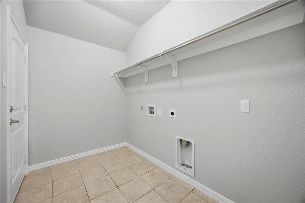 408 Northgate Drive, Terrell, TX 75160 Vaulted ceiling laundry area with tile flooring and a built-in storage shelf and clothing rod