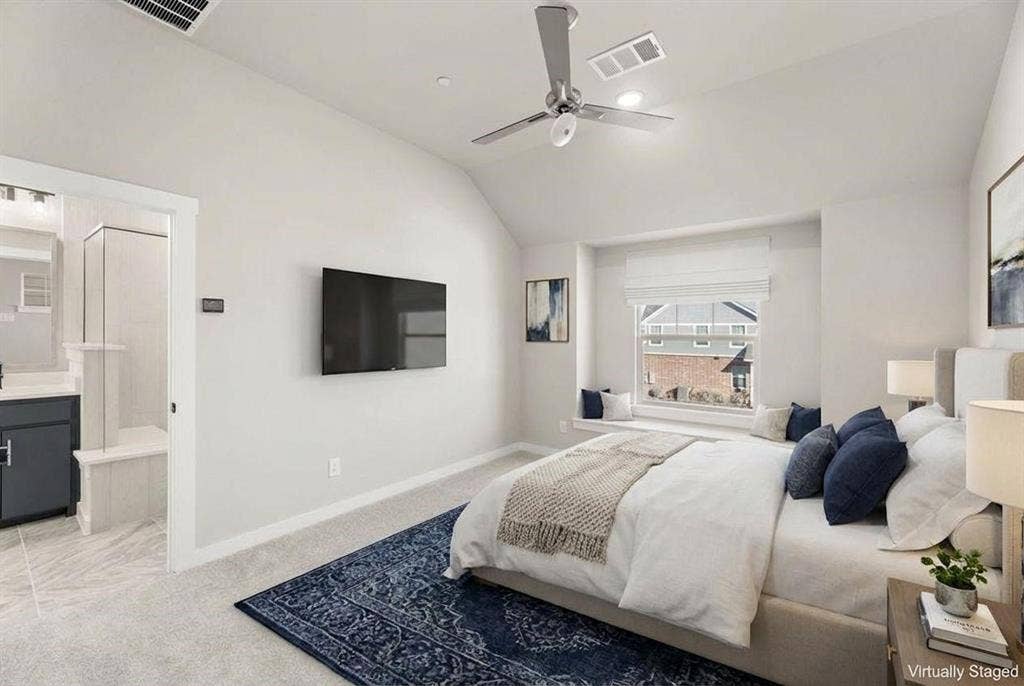 604 Nolan Lane, Wylie, TX 75098 Vaulted ceiling featuring a ceiling fan, window alcove with built-in bench seating, and wall-mounted television