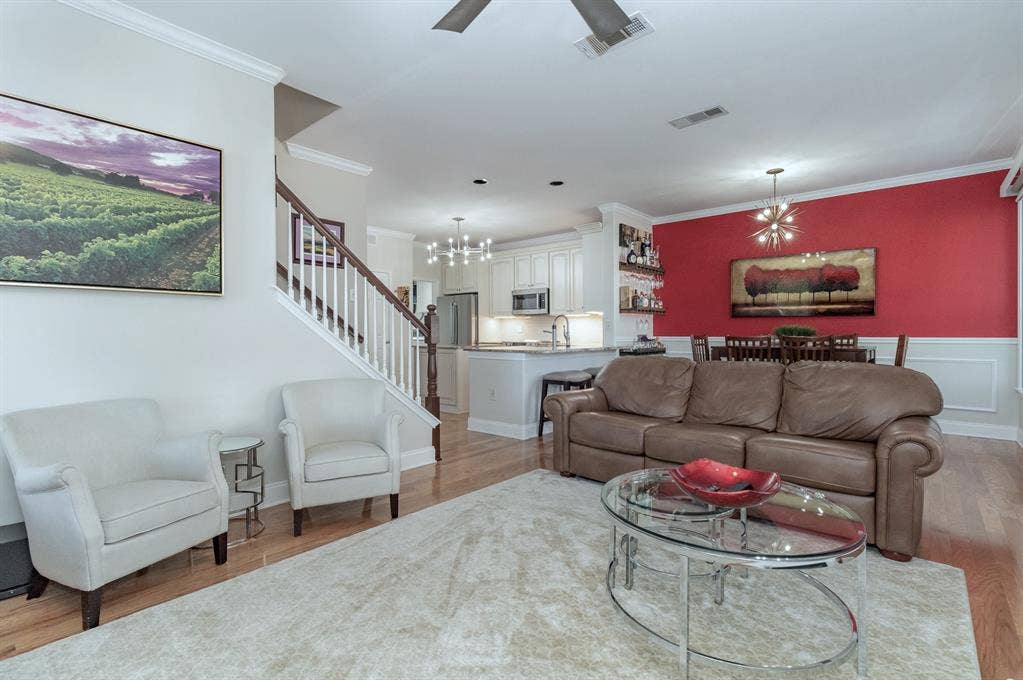 2800 Keller Springs Road, #8C, Carrollton, TX 75006 Living area is adjacent to dining and kitchen. Wood flooring throughout the open living areas.