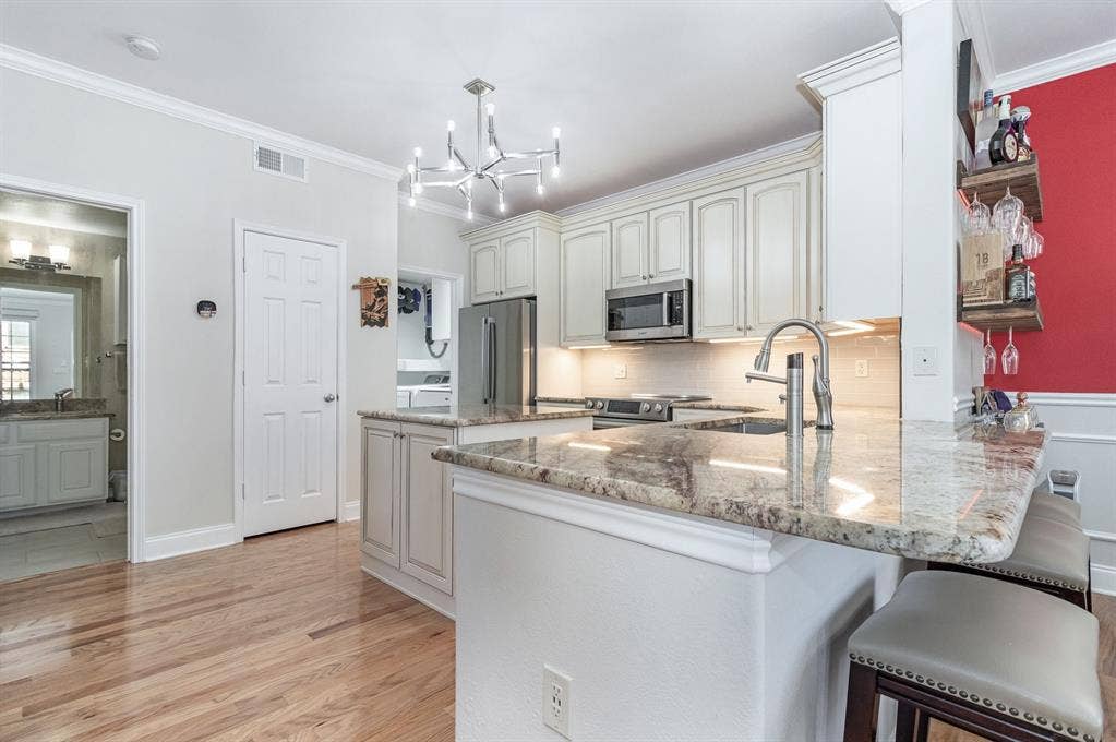 2800 Keller Springs Road, #8C, Carrollton, TX 75006 Kitchen has breakfast bar, state of the art Bosch appliances and spacious pantry.