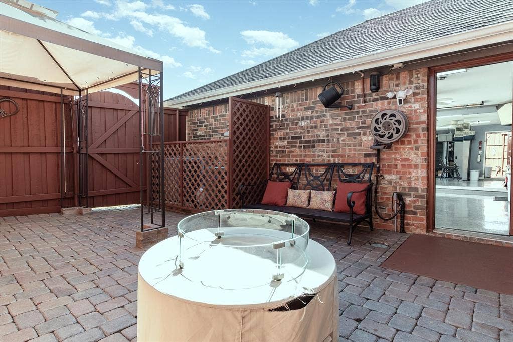 2800 Keller Springs Road, #8C, Carrollton, TX 75006 Awning section of side yard patio area. Lattice fencing shields the two over-capacity HVAC units.
