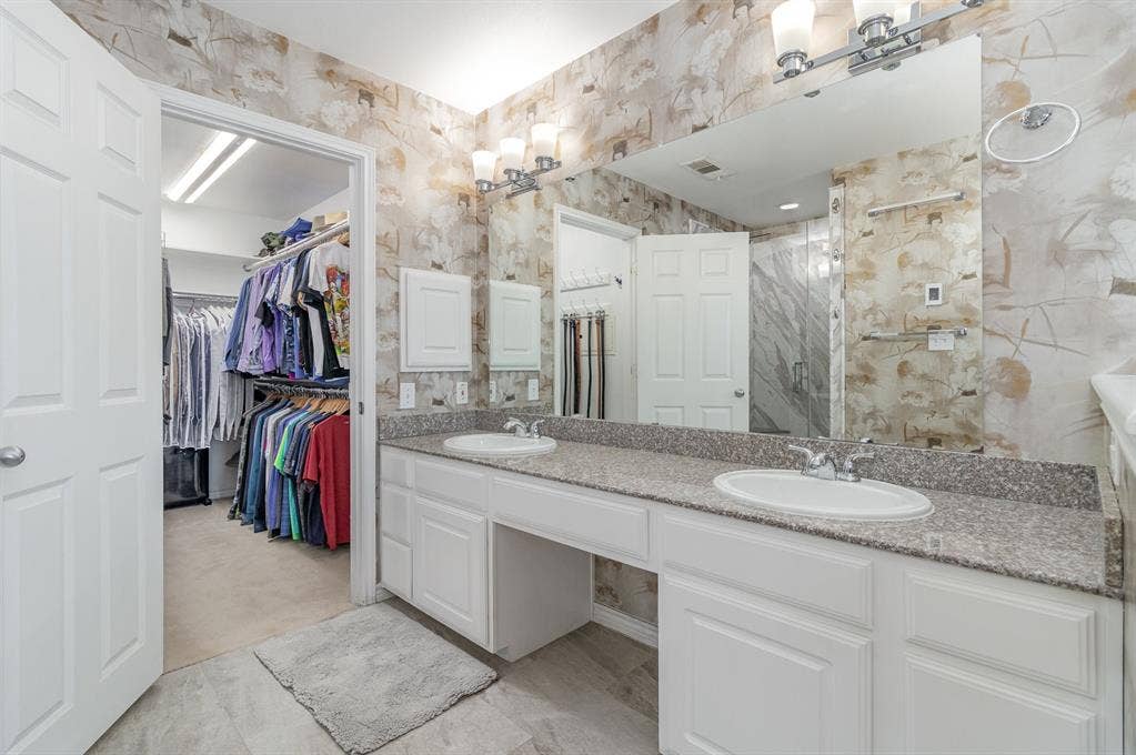 2800 Keller Springs Road, #8C, Carrollton, TX 75006 Primary bath has dual sinks, new light fixtures, designer wallpaper, new floor tile and HEATED floors! Walk-in closet was custom-designed.