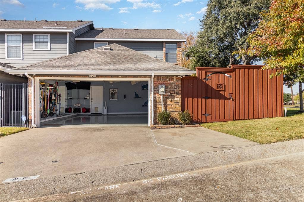 2800 Keller Springs Road, #8C, Carrollton, TX 75006 Inside garage there is extra storage (on left) and plenty of space for two cars in 20x20 area. Exterior lights and cameras convey.