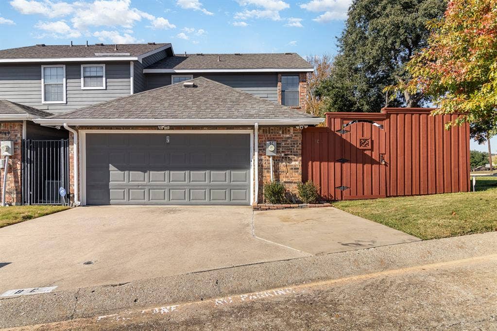2800 Keller Springs Road, #8C, Carrollton, TX 75006 2-car garage has been updated with extra wall and ceiling insulation and has additional custom lighting. Floor is epoxy covered. Driveway has additional parking pad so that three full-size vehicles are easily accommodated.