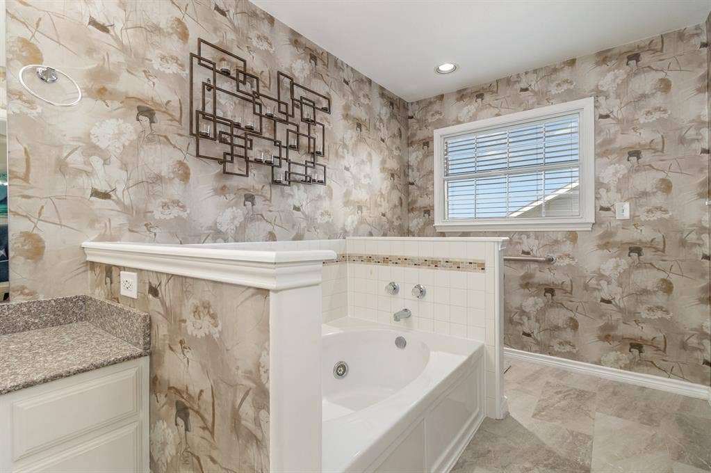 2800 Keller Springs Road, #8C, Carrollton, TX 75006 Jetted garden tub in primary bath, recessed LED lighting to complement the natural light.