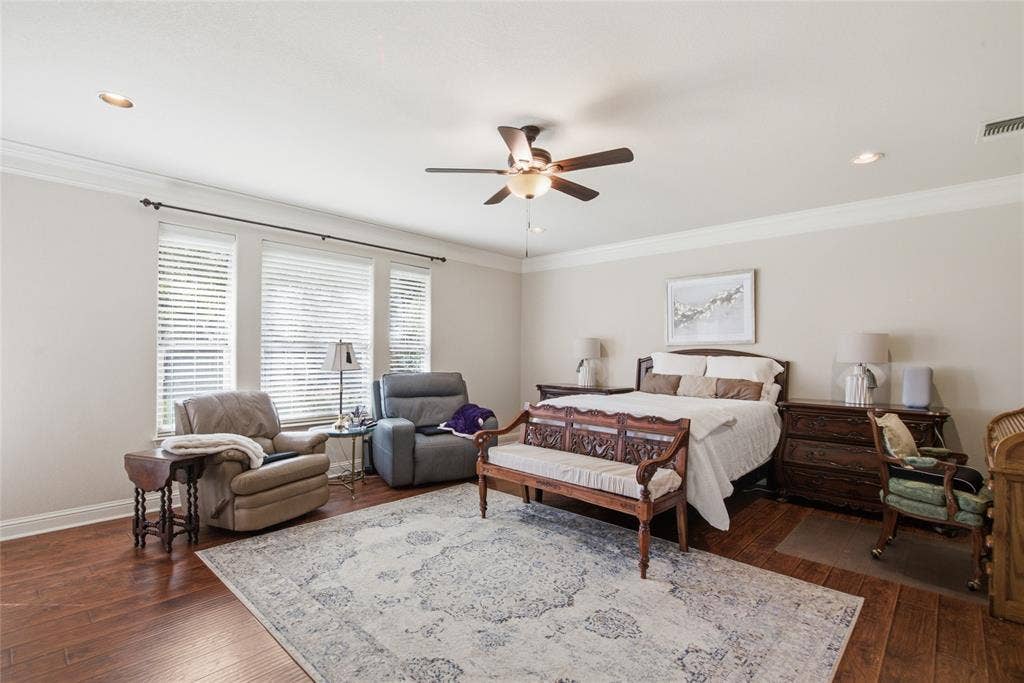 Spacious Primary Master Bedroom featuring wood-finish flooring, crown molding, recessed lighting, and a central ceiling fan