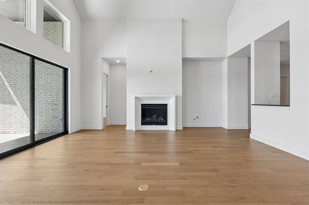 8729 Porch Place, McKinney, TX 75071 You'll enjoy a spacious family room featuring high ceilings, beautiful flooring, cozy fireplace and a wall of windows in our over the top Madison II plan!