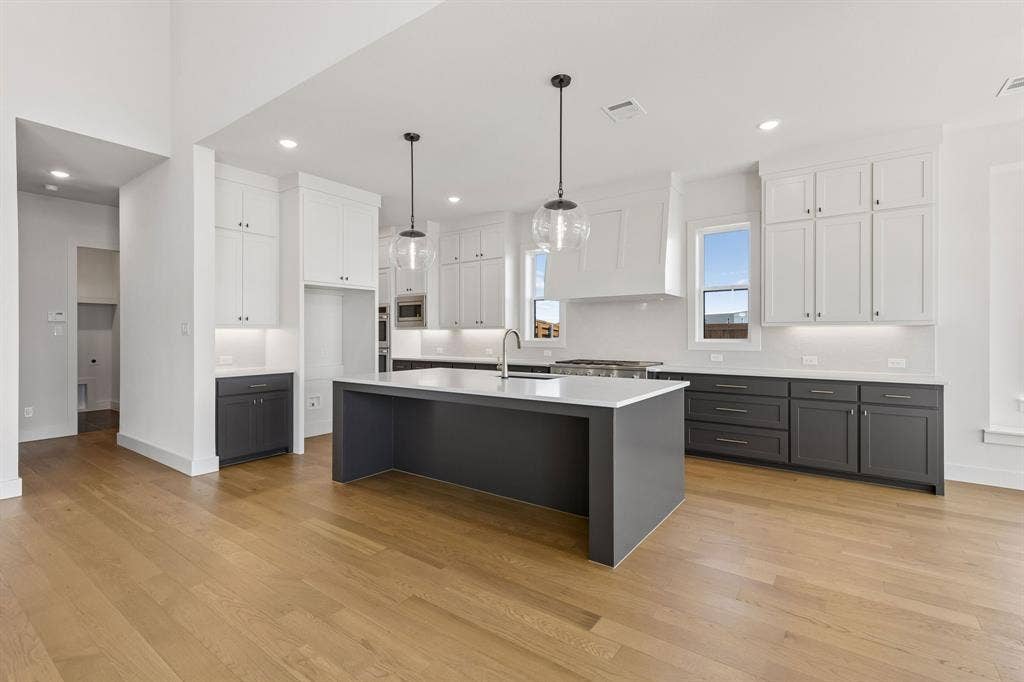 8729 Porch Place, McKinney, TX 75071 With striking two tone cabinetry, beautiful white countertops and top of the line appliances, this dream kitchen offers plenty of space for all the chefs in the family!