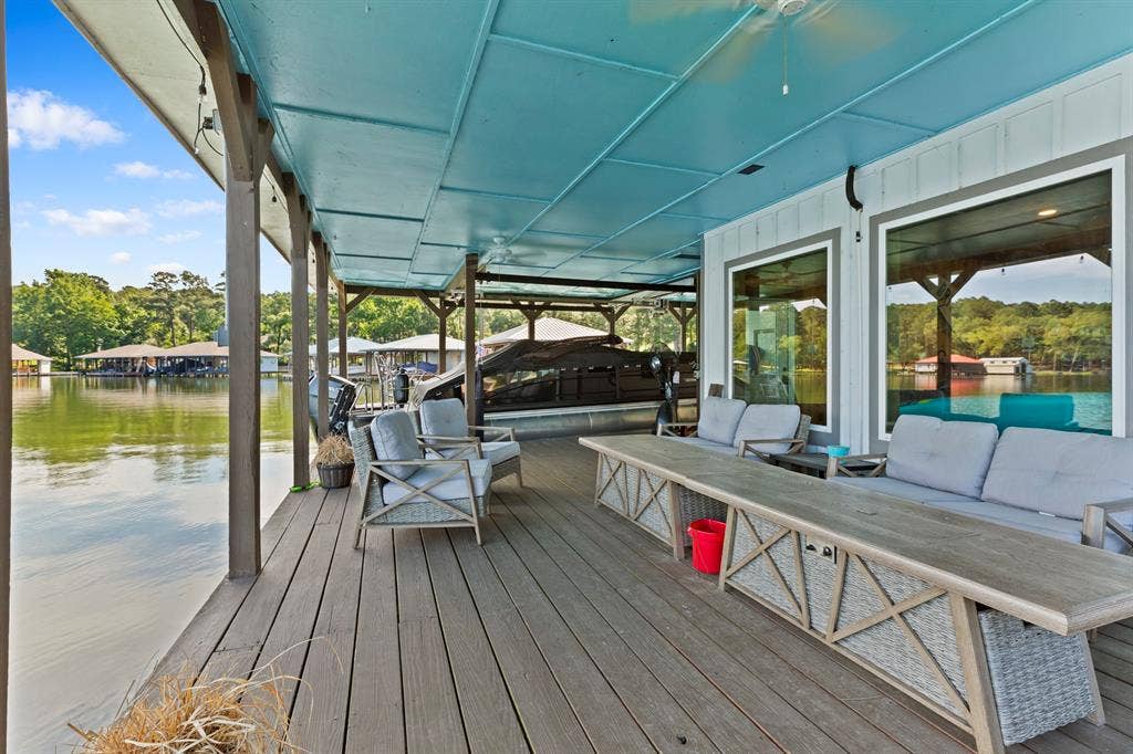 18630 Eastside Road, Troup, TX 75789 Expansive covered dock with wood-finish decking and integrated boat slips