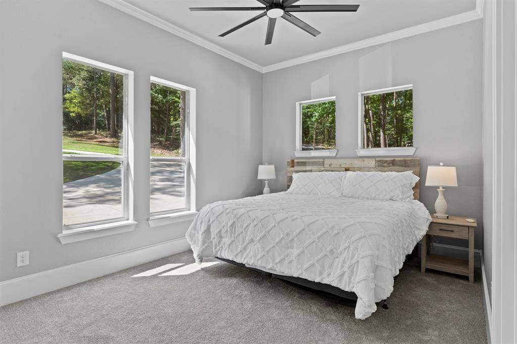 18630 Eastside Road, Troup, TX 75789 Wall-to-wall carpeting, multiple windows, crown molding, and a ceiling fan