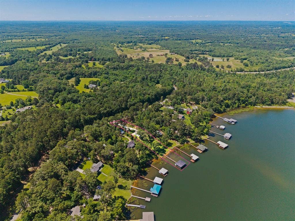18630 Eastside Road, Troup, TX 75789 Expansive waterfront property featuring a private dock and a mature tree-lined landscape
