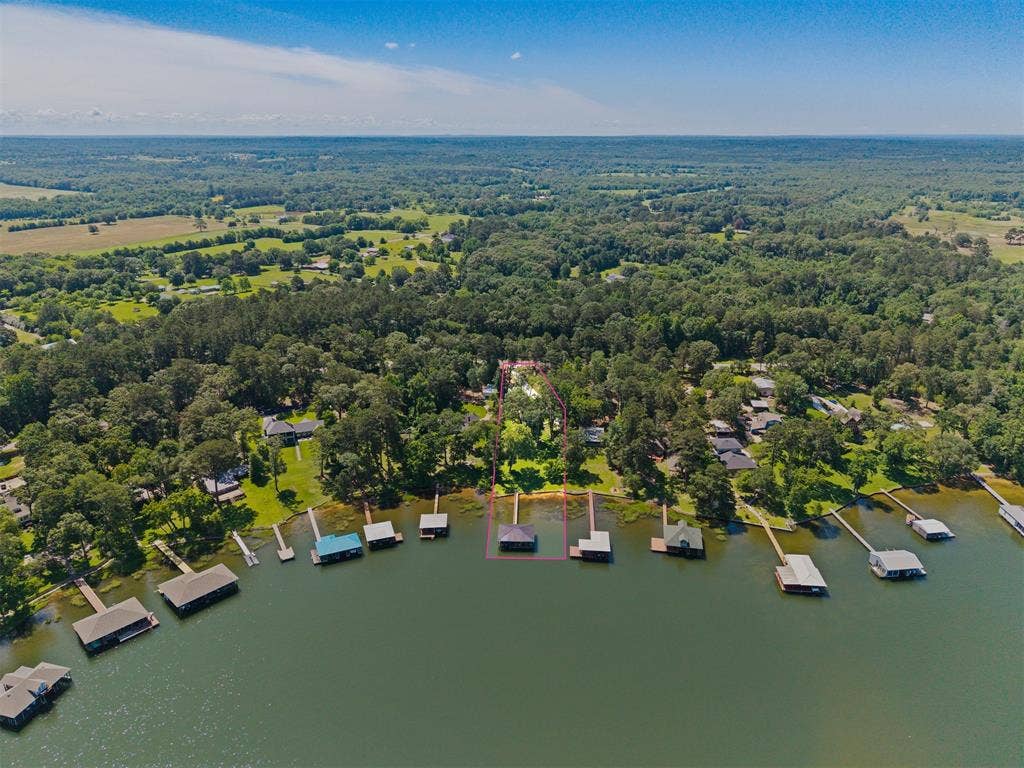 18630 Eastside Road, Troup, TX 75789 Waterfront property featuring a private boat house with a covered slip and an additional uncovered dock