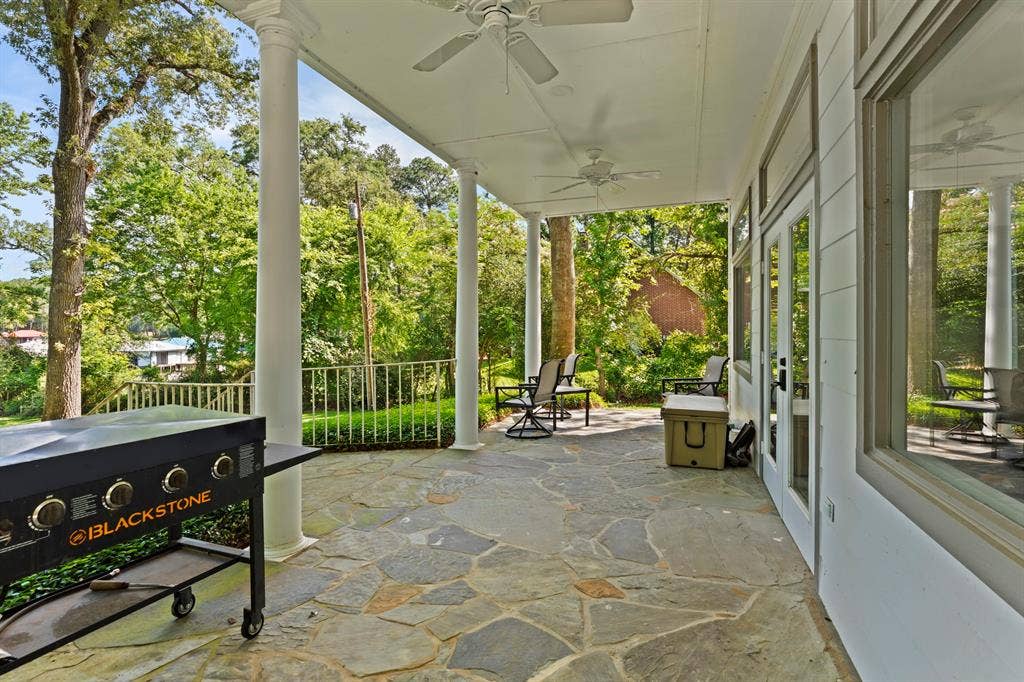 18630 Eastside Road, Troup, TX 75789 Covered patio with a flagstone surface, supported by white columns, featuring recessed lighting and ceiling fans