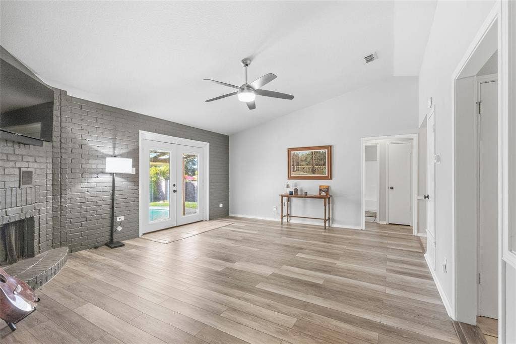 5010 Utah Street, Greenville, TX 75402 Vaulted ceiling, ceiling fan, wood-finish flooring, painted brick fireplace, double French doors