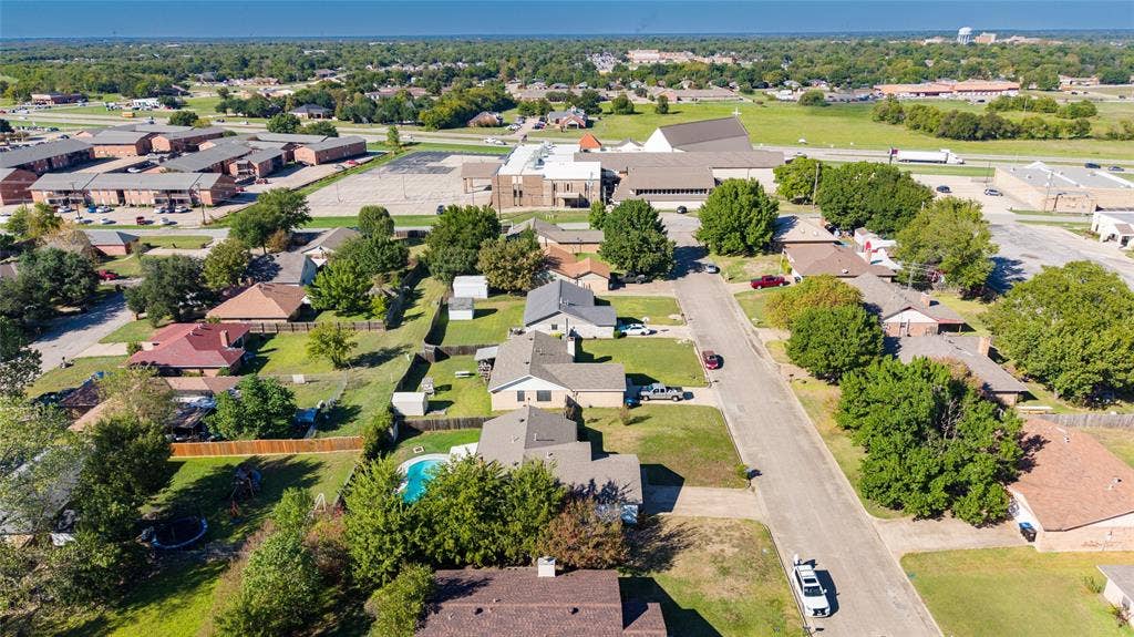 5010 Utah Street, Greenville, TX 75402 Expansive neighborhood setting with numerous mature trees and a residential street