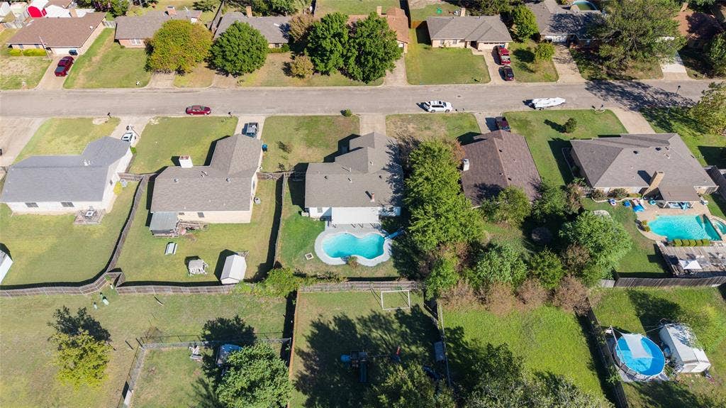5010 Utah Street, Greenville, TX 75402 Property featuring an in-ground swimming pool, fenced yard, and an additional storage shed