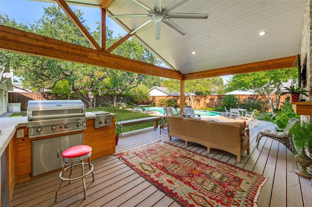 4521 Nashwood Lane, Dallas, TX 75244 Expansive covered patio with exposed wood beams, composite decking, built-in outdoor kitchen, recessed lighting, and ceiling fan