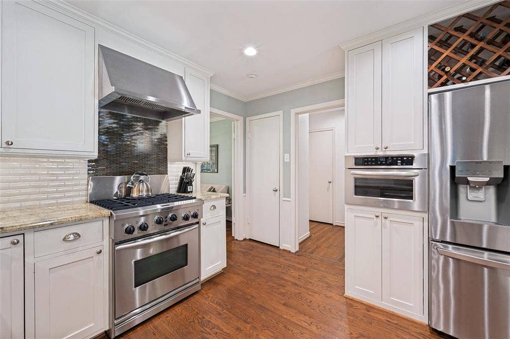4521 Nashwood Lane, Dallas, TX 75244 White shaker-style cabinetry with brushed nickel hardware