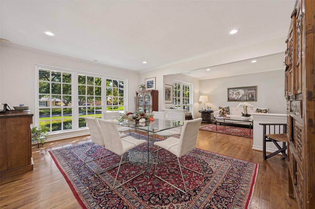 4521 Nashwood Lane, Dallas, TX 75244 Hardwood flooring throughout, recessed lighting, white crown molding, large multi-pane windows, and a half-wall partition