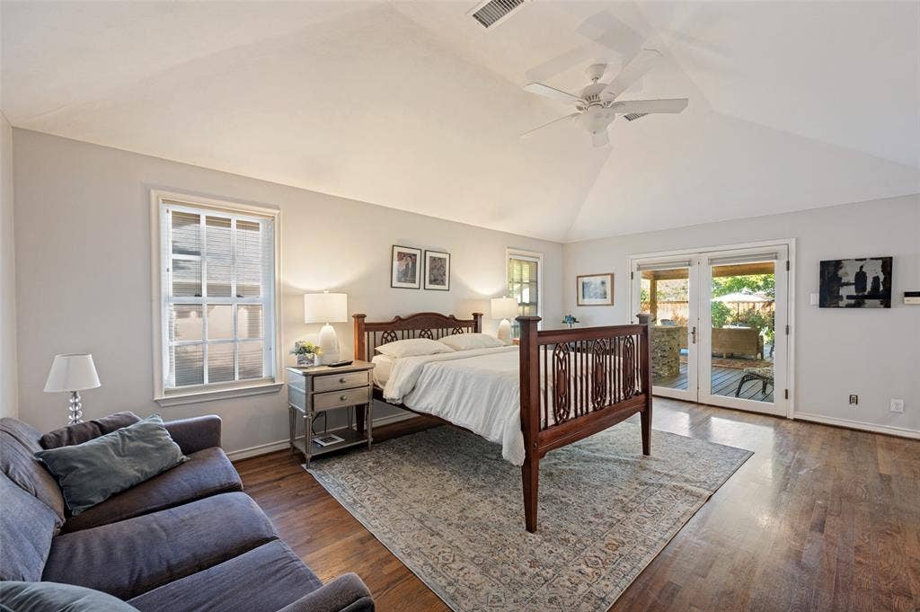 4521 Nashwood Lane, Dallas, TX 75244 Vaulted ceiling with a ceiling fan, hardwood flooring, white double-pane windows, and patio access via glass French doors