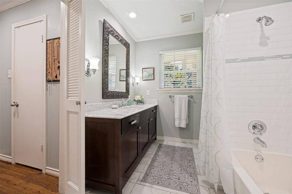 4521 Nashwood Lane, Dallas, TX 75244 White marble countertops with an integrated sink, and dark wood-finish cabinetry