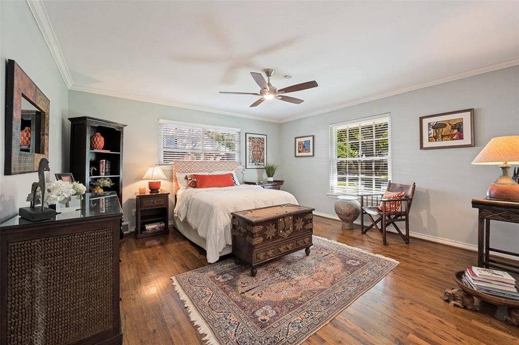 4521 Nashwood Lane, Dallas, TX 75244 Hardwood flooring, ceiling fan, crown molding, and multiple windows with blinds