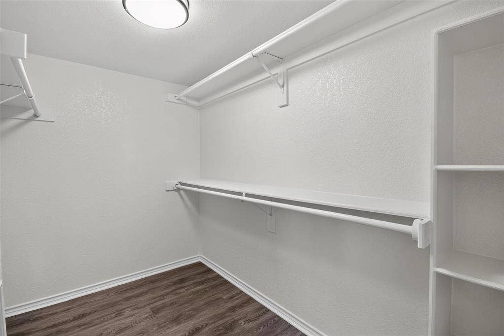 1101 Boyd Drive, Wylie, TX 75098 Walk-in closet with wood-finish flooring, built-in shelving, and hanging rods