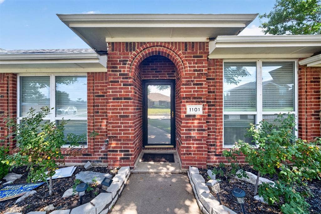 1101 Boyd Drive, Wylie, TX 75098 Red brick exterior with an arched entryway and a glass paneled door