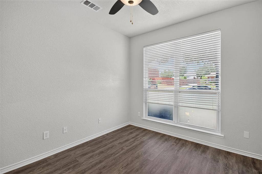 1101 Boyd Drive, Wylie, TX 75098 Recessed ceiling fixture, wood-finish flooring, and a large window with blinds