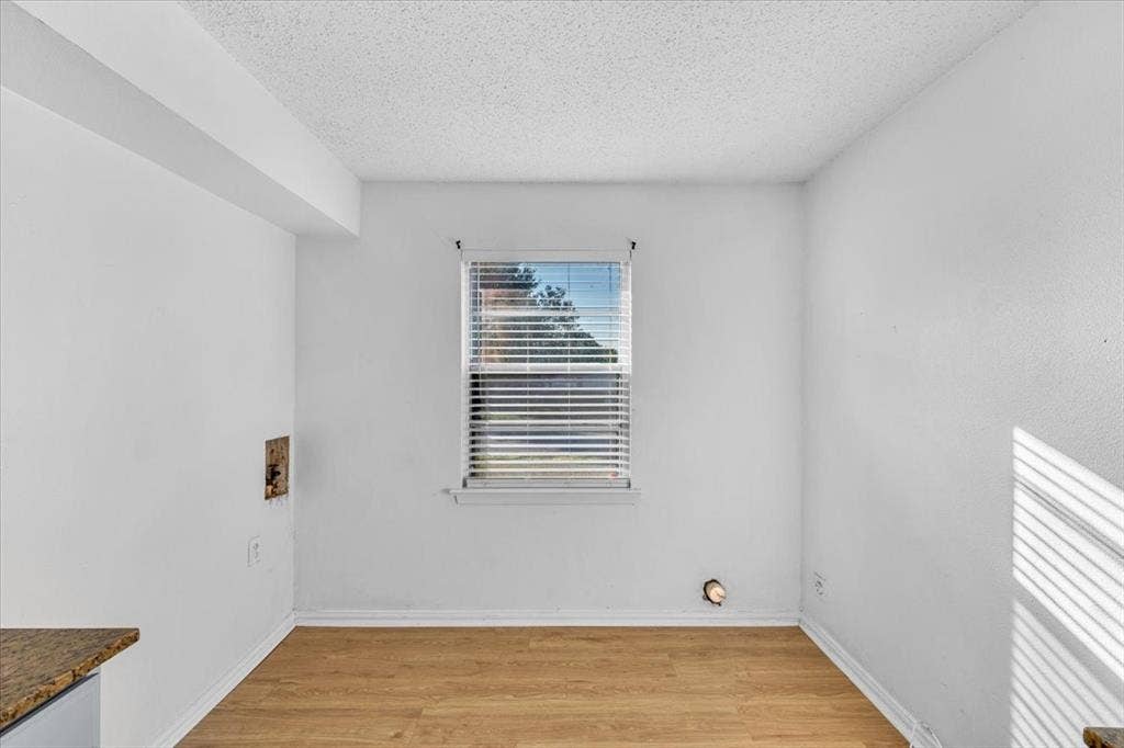 13521 Flagstone Lane, Dallas, TX 75240 Wood-finish flooring with white walls