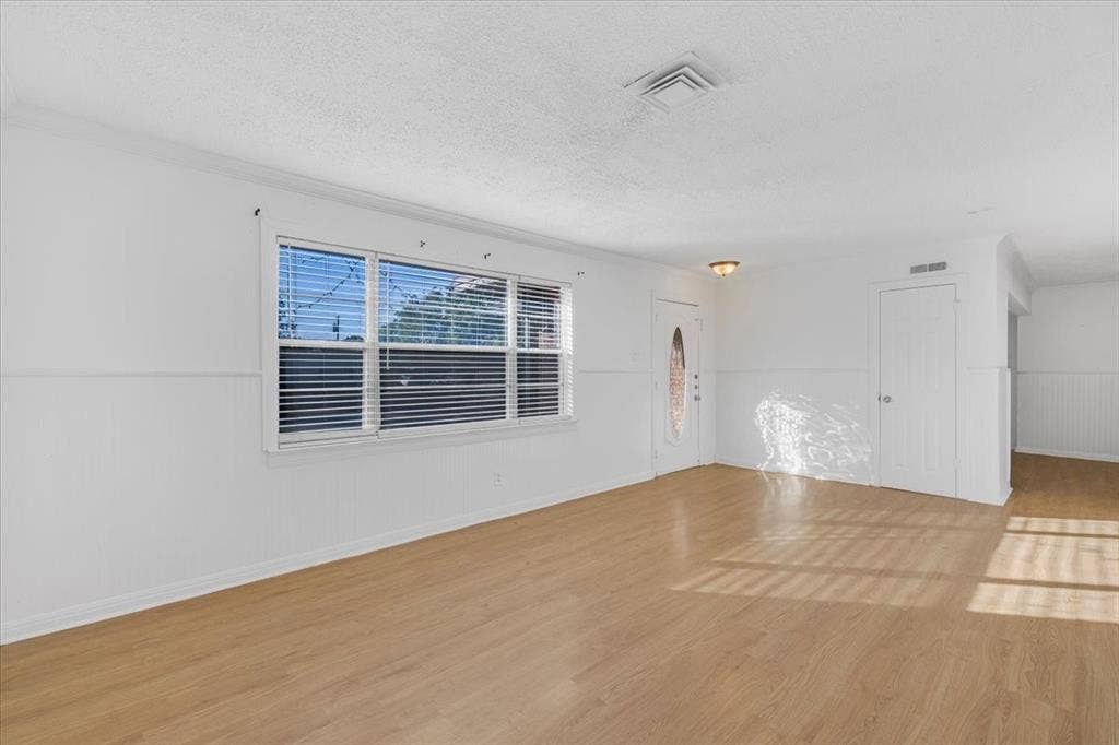 13521 Flagstone Lane, Dallas, TX 75240 Hardwood-finish flooring, white paneled walls, and built-in overhead lighting