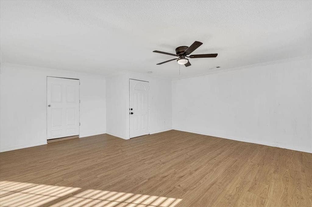 13521 Flagstone Lane, Dallas, TX 75240 Wood-finish flooring, white walls, and a ceiling fan with integrated lighting