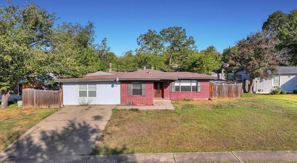 13521 Flagstone Lane, Dallas, TX 75240 Brick and siding exterior with a single-car concrete driveway