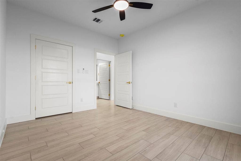 Recessed lighting, wood-finish flooring, white paneled doors, ceiling fan with light fixture, and neutral wall tones